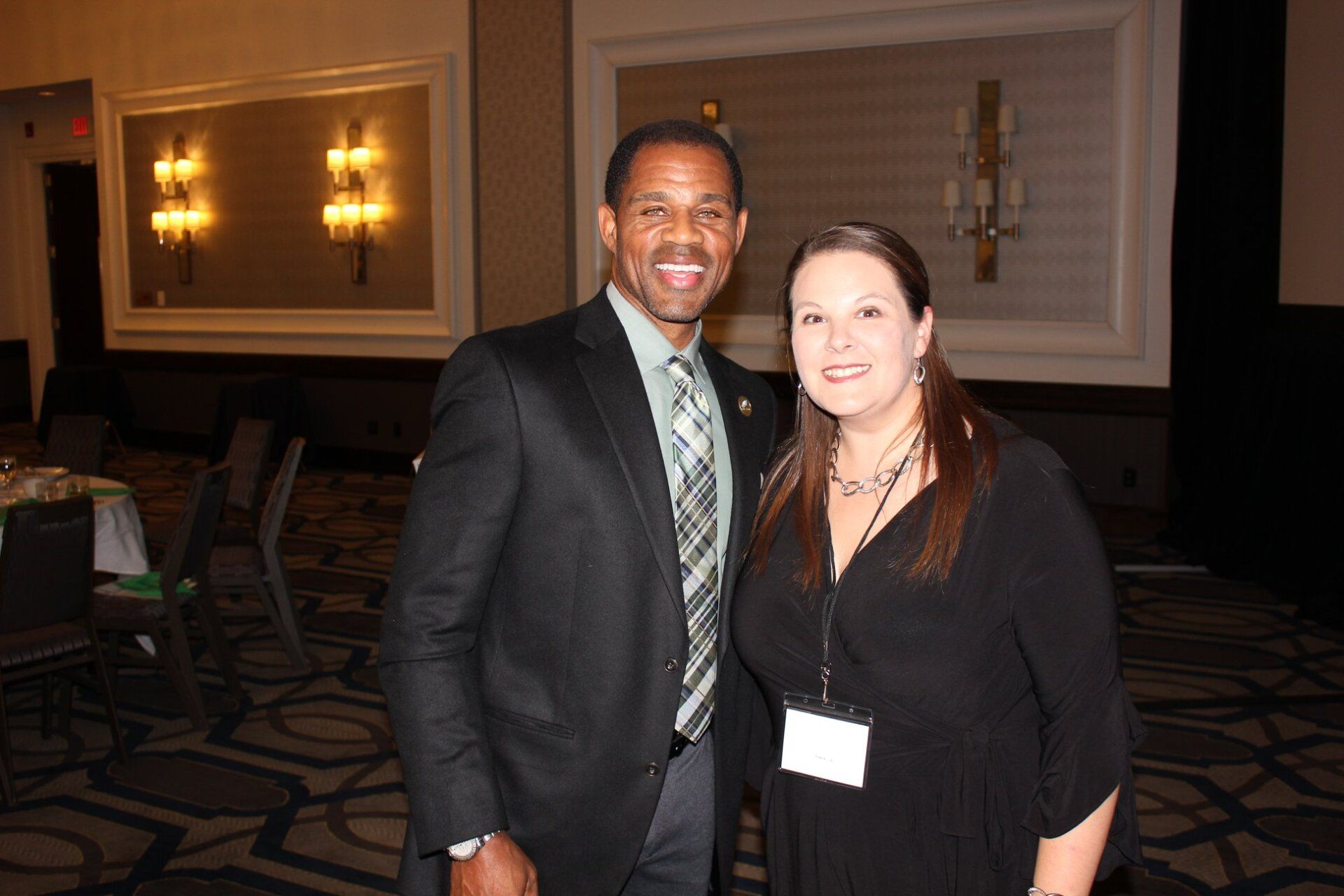 A man and a woman are posing for a picture in a room.