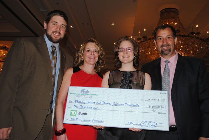 A group of people holding a check that says td bank on it