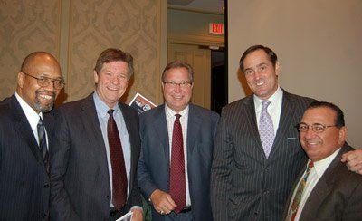 A group of men in suits and ties posing for a picture