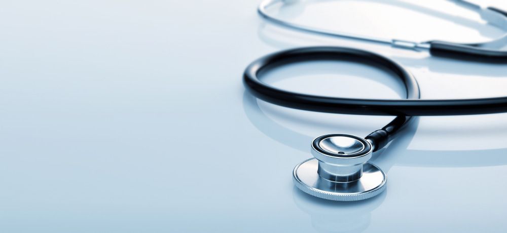 A Close Up Of A Stethoscope On A Blue Surface — Mall Medical Centre In Alice Springs, NT