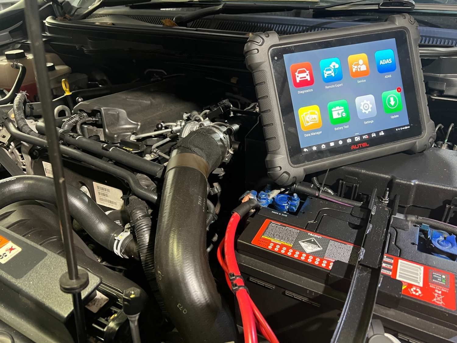 A Ipad is sitting on a inside of a car bonnet  — Advanced Automotive Services in Coffs Harbour, NSW