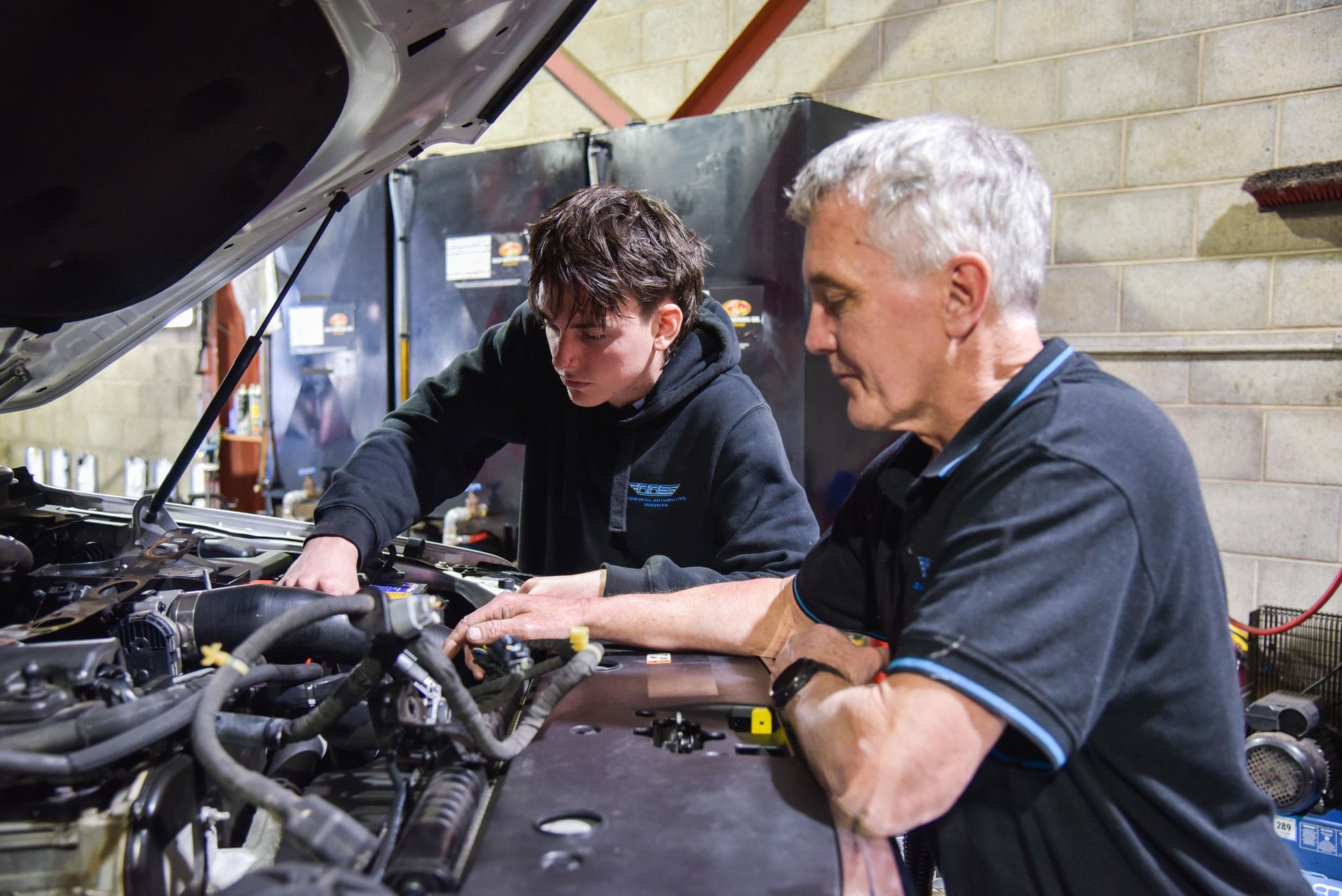 Tow men are looking into a car bonnet — Advanced Automotive Services in Coffs Harbour, NSW