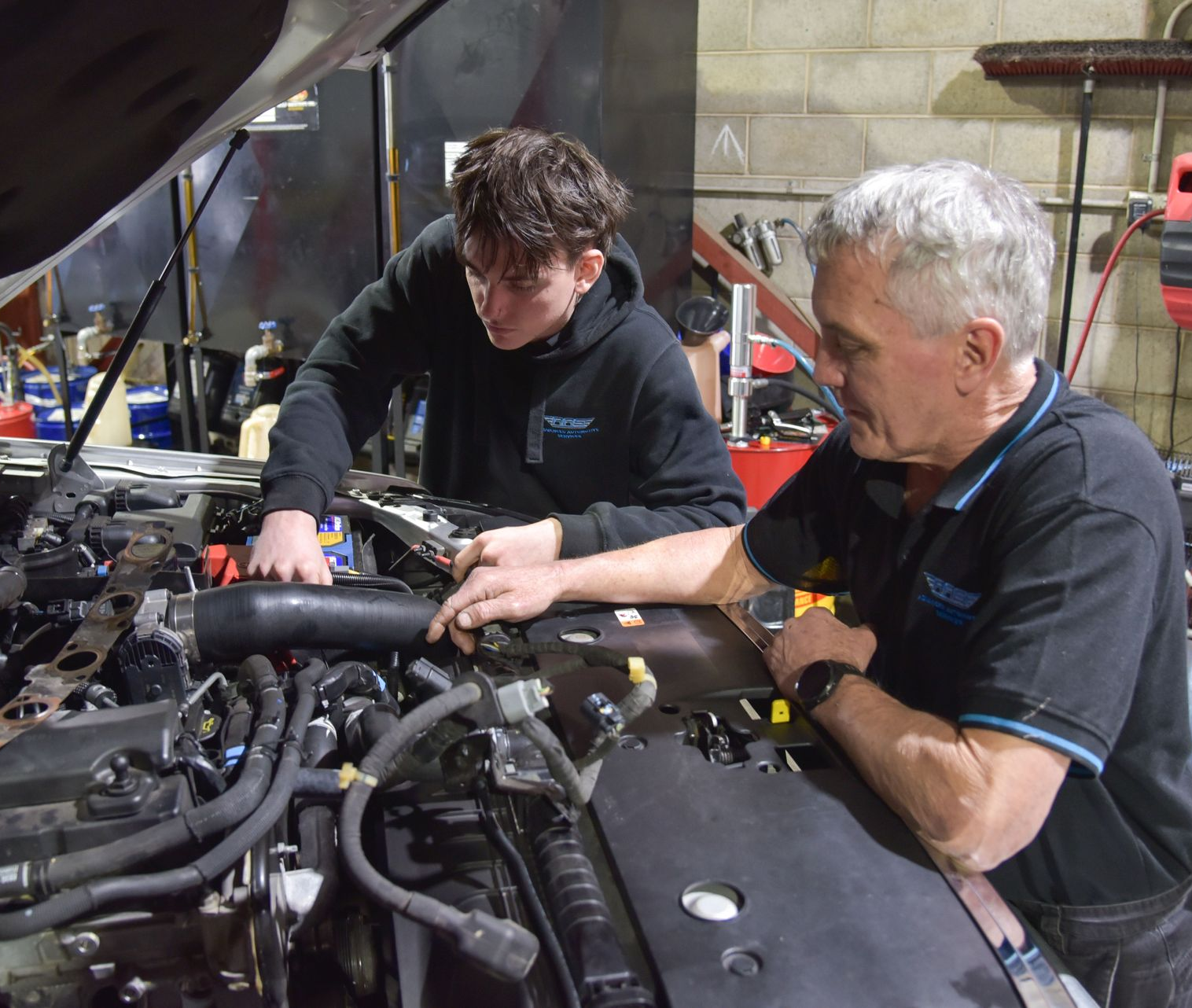 Two men are looking into bonnet of a car — Advanced Automotive Services in Coffs Harbour, NSW