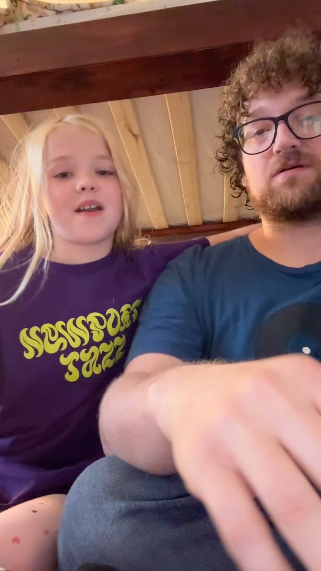 A man and a little girl are sitting next to each other