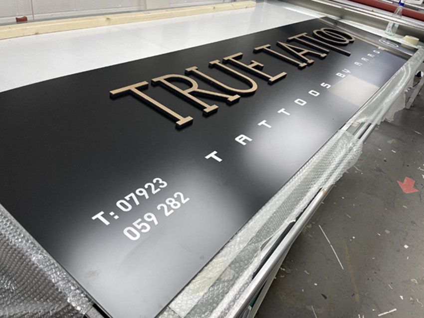 Black sign with gold 