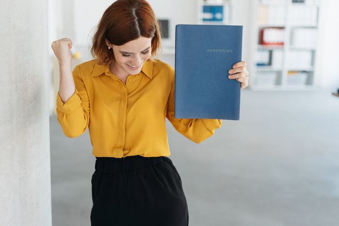 Woman Celebrating Getting a Job — Saginaw, MI — APS Employment Services, Inc Woman Celebrating Getting a Job — Saginaw, MI — APS Employment Services, Inc