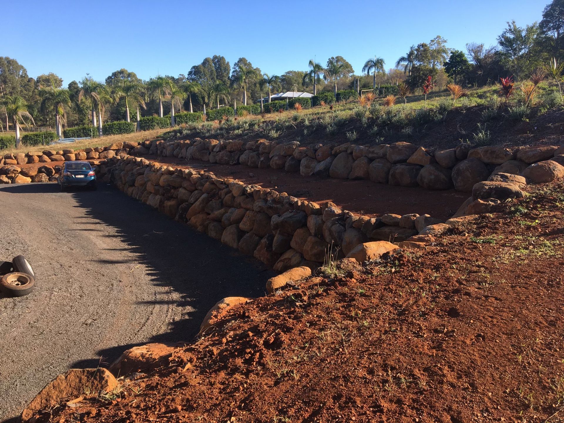 A Gravel Driveway Bordered by Rock Walls— A1 Rock This City Truck & Dog Hire In Good Night, QLD