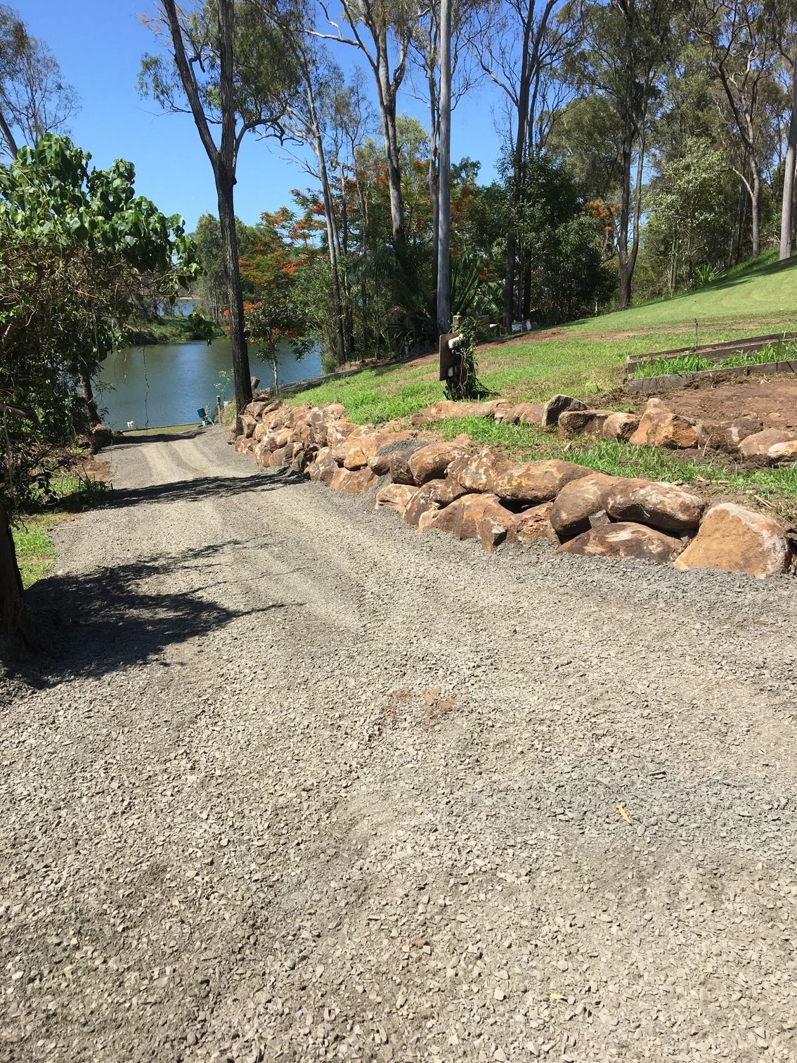 Gravel Driveway Slopes Down to Water — A1 Rock This City Truck & Dog Hire In Good Night, QLD