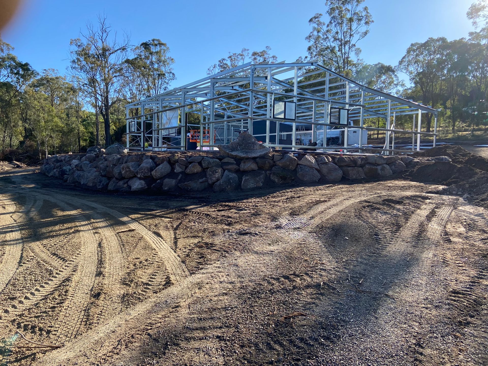 Construction Site: Steel Frame Structure on A Rock Retaining Wall — A1 Rock This City Truck & Dog Hire In Good Night, QLD