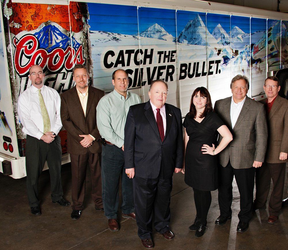 people standing by a Coors Light truck