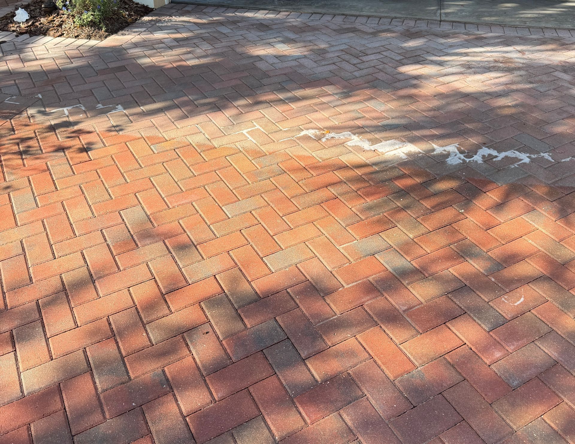 Paver surface before and after failed sealer removal and resealing