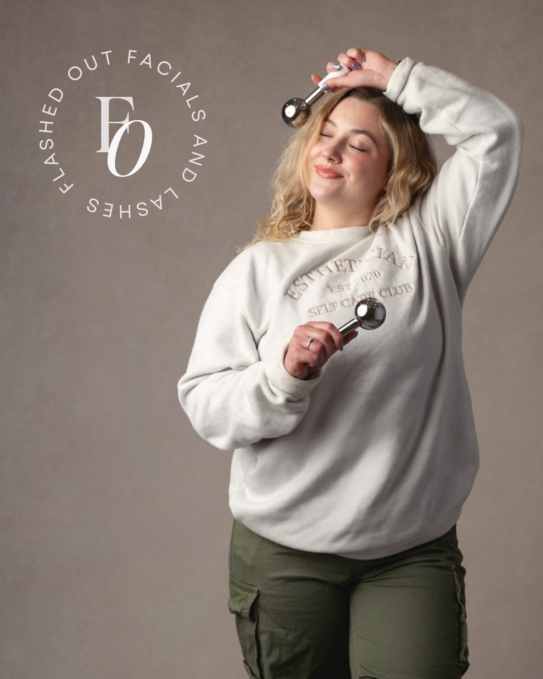 Woman in a white sweatshirt holding dumbbells in a studio, eyes closed, with a circular logo beside her.