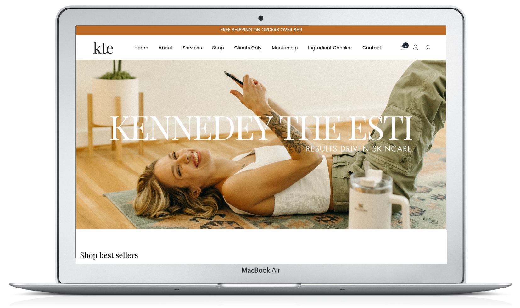 A woman is laying on a yoga mat looking at her phone. kennedey the esti brand