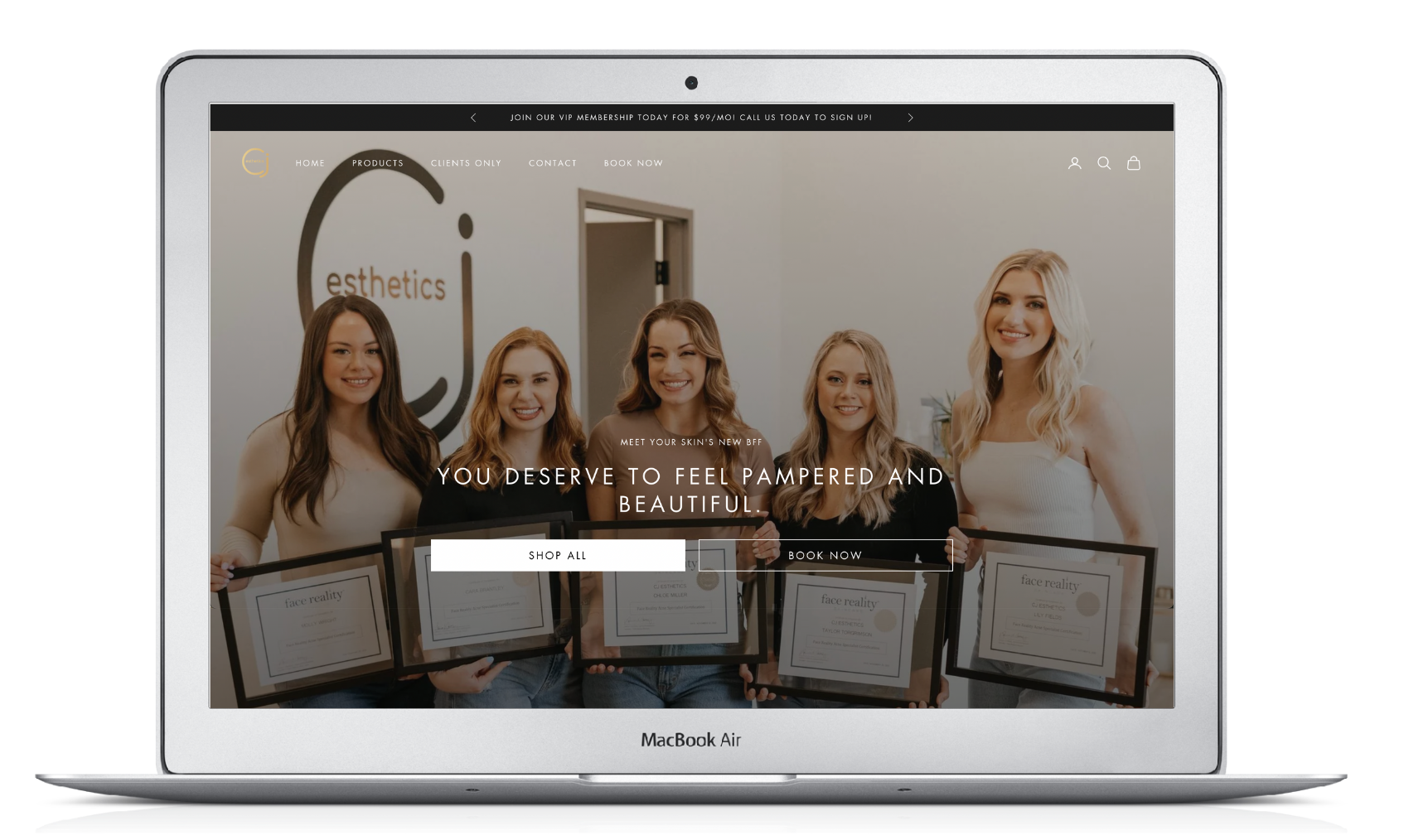A laptop with a picture of a group of women holding certificates on the screen.
