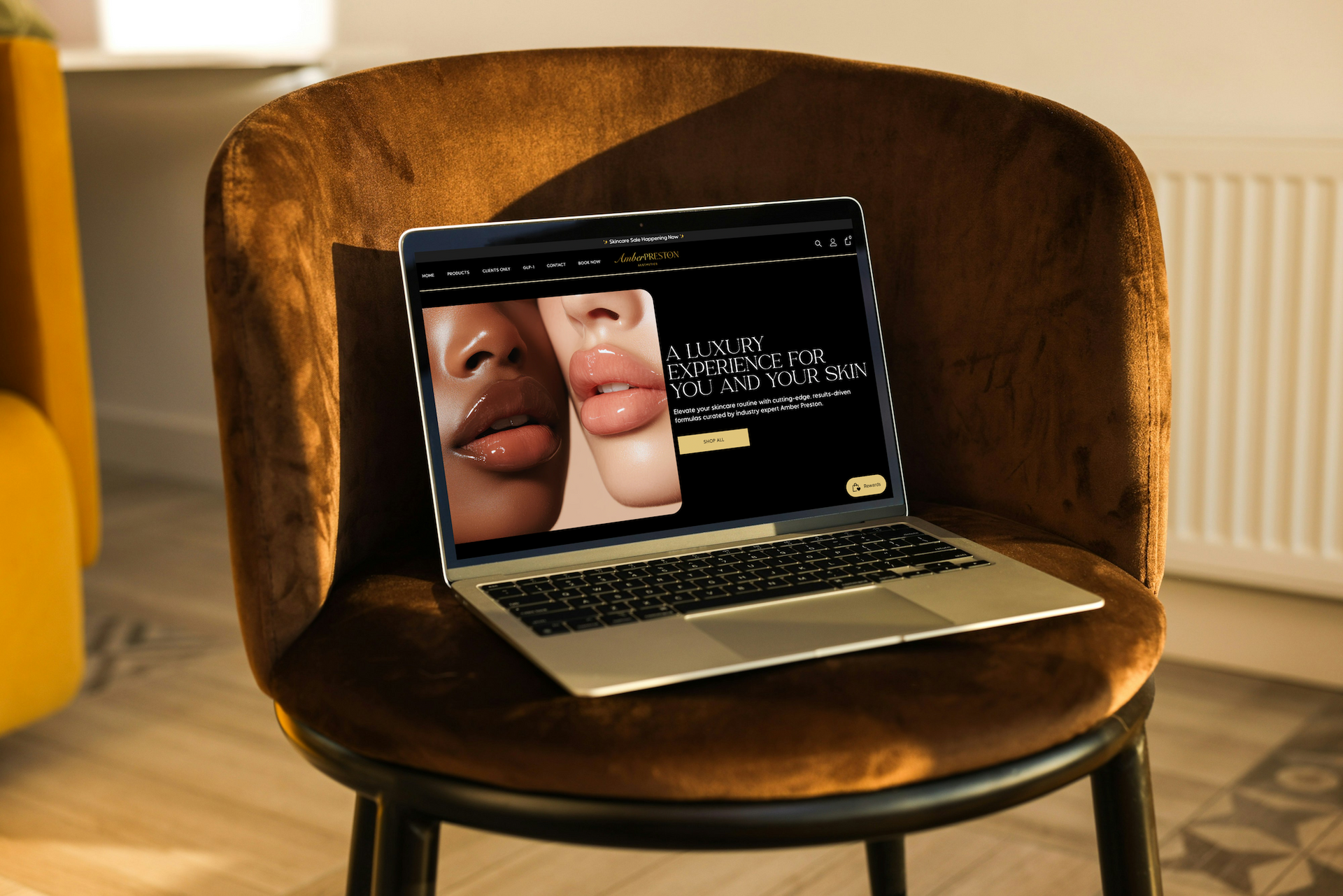 Laptop on a brown chair displaying a split-screen close-up of lips and a dark interface.