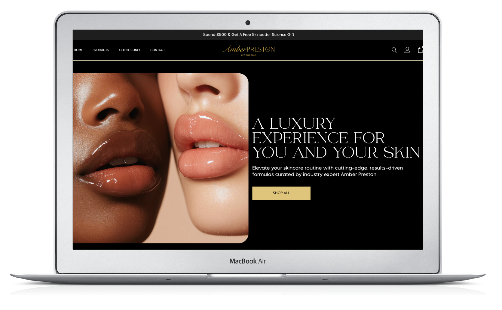 Laptop displaying a skincare website with close-up lips and skin tones on a black background