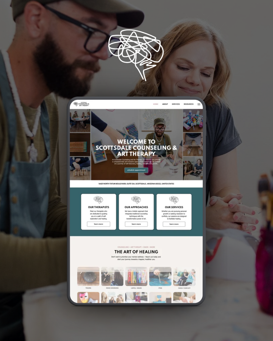 Two people looking at a tablet showing a website on a blurred café table background