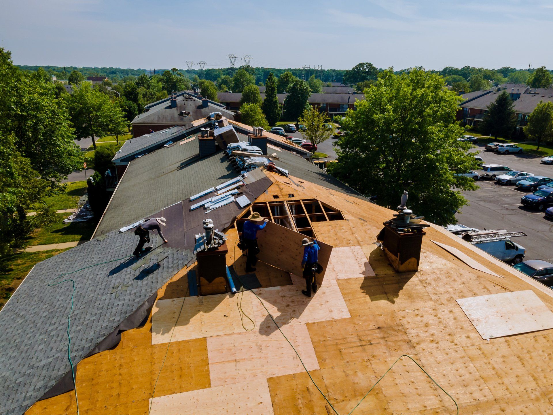 A group of people are working on the roof of a building.