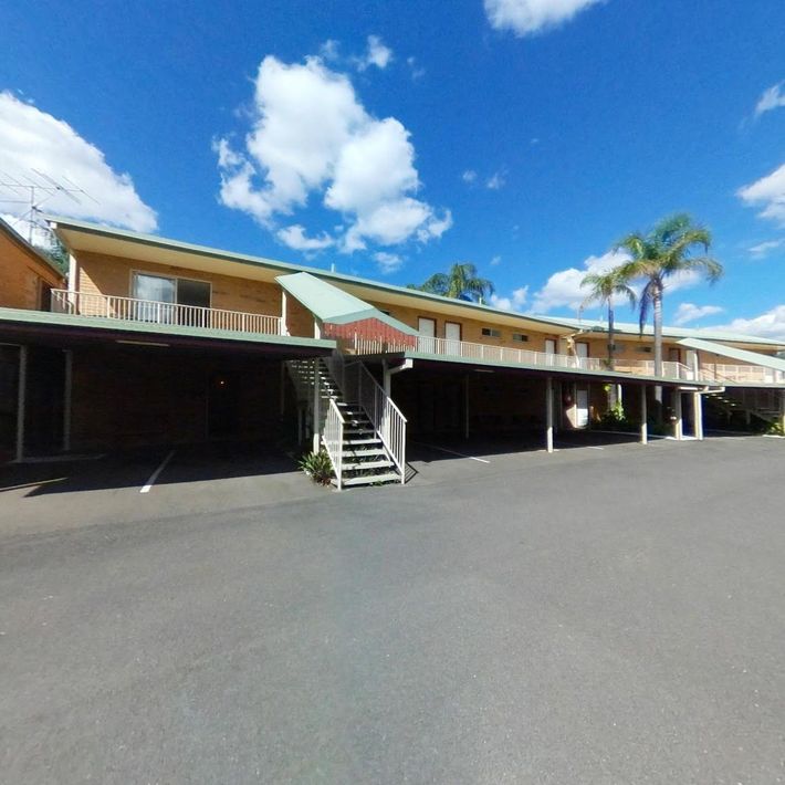 A Large Building With Stairs Leading Up to It — Country Comfort Gin Gin Wild Scotsman Motor Inn in Gin Gin, QLD
