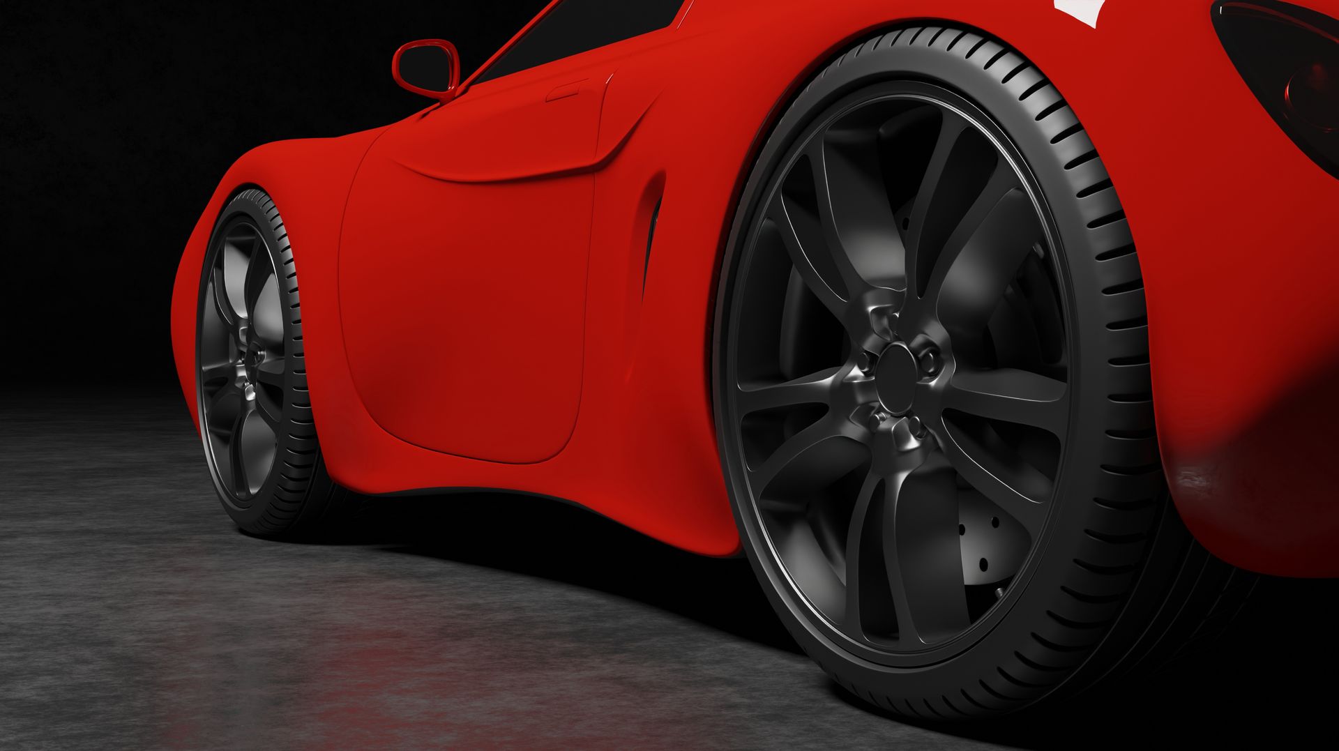A red sports car with black wheels and tires