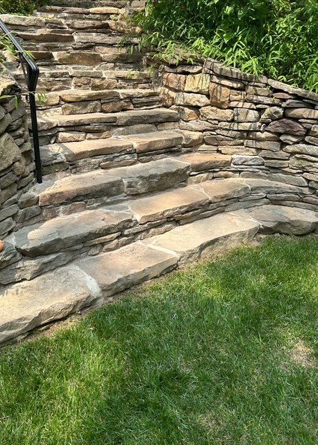 Stone steps leading uphill, built into a grassy hillside.