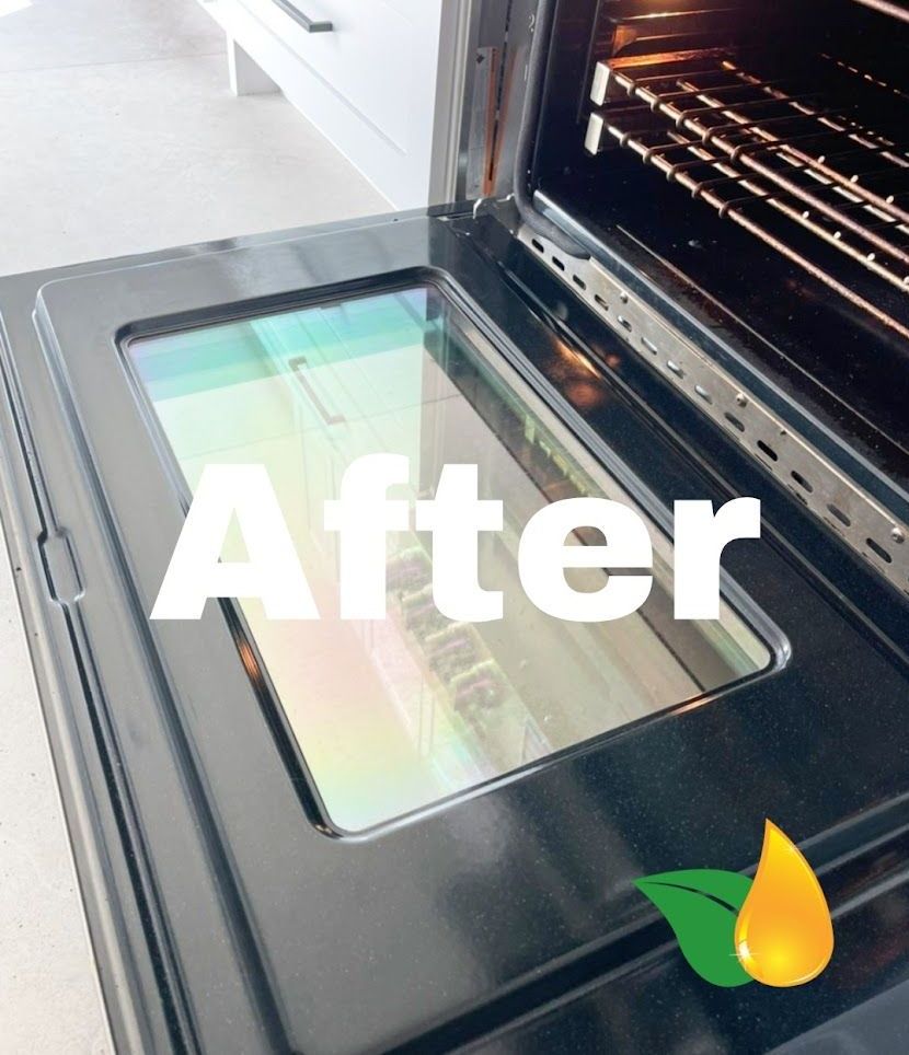 An open oven with a clean, clear glass door, marked with 