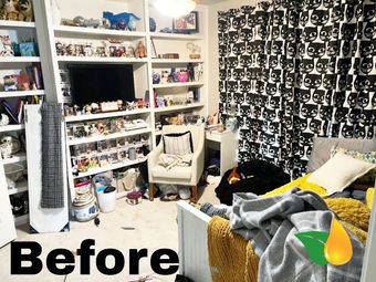 Cluttered bedroom before cleanup, with shelves, TV, chair, bed, and black patterned wall covering.