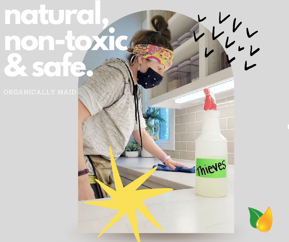 A person wearing a mask and headband cleans a kitchen counter with a spray bottle labeled 
