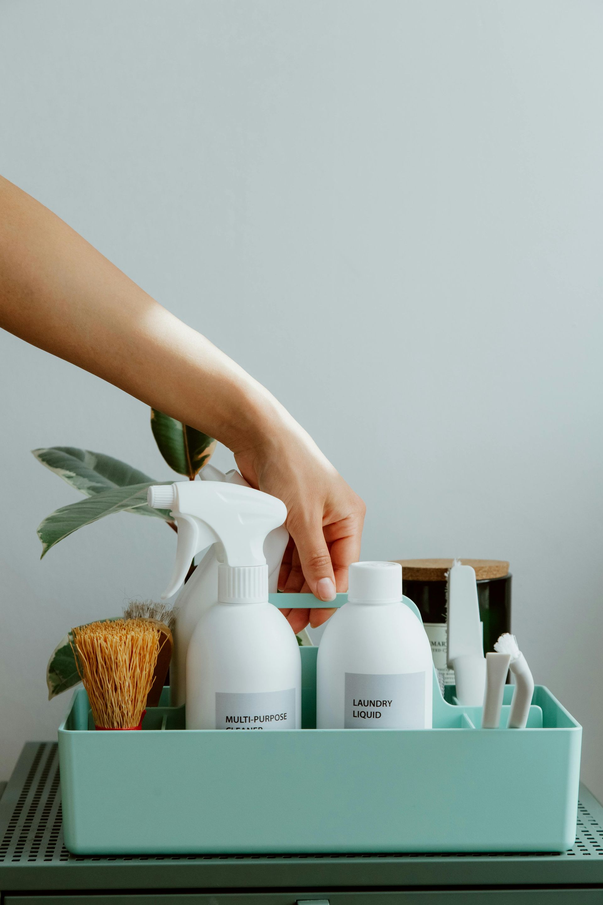 Green caddy with natural supplies for maid home cleaning services