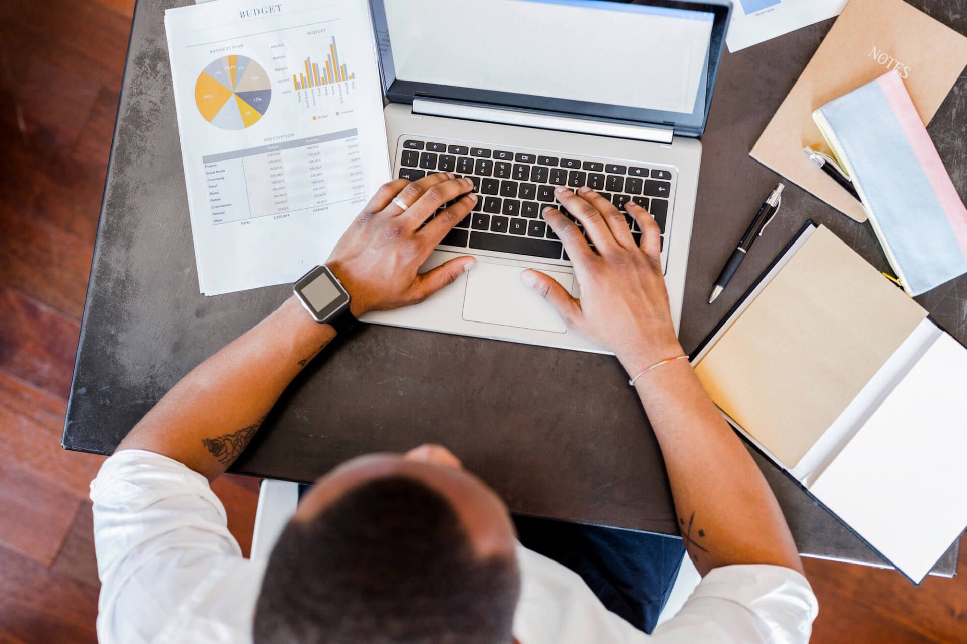 Man using laptop at desk in home office