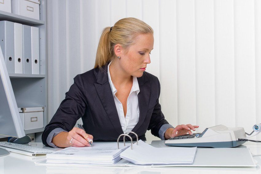 A female accountant with a ring binder folder