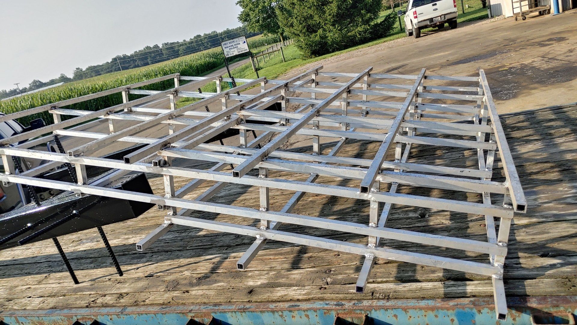 Metal frame structure on a flatbed trailer, likely for a building, outdoors.