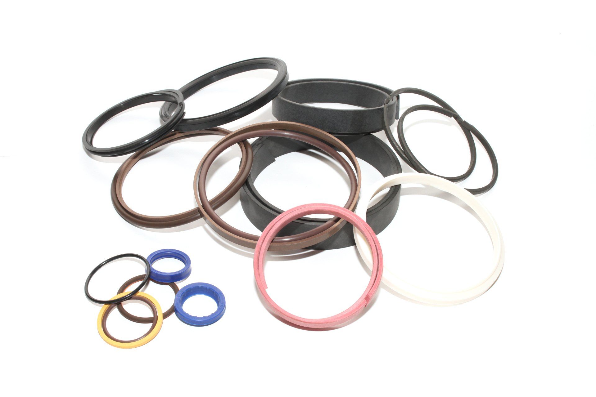 Various colored O-rings scattered on a white surface.