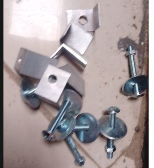 Assorted metal screws, bolts, and brackets scattered on a beige surface