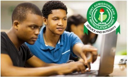 Two students using a desktop computer, with the JAMB logo in the top right corner