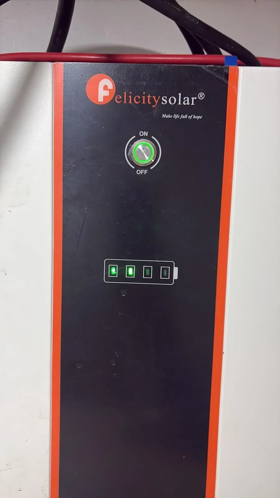 Black FierySolar power inverter with orange side accents and green control lights
