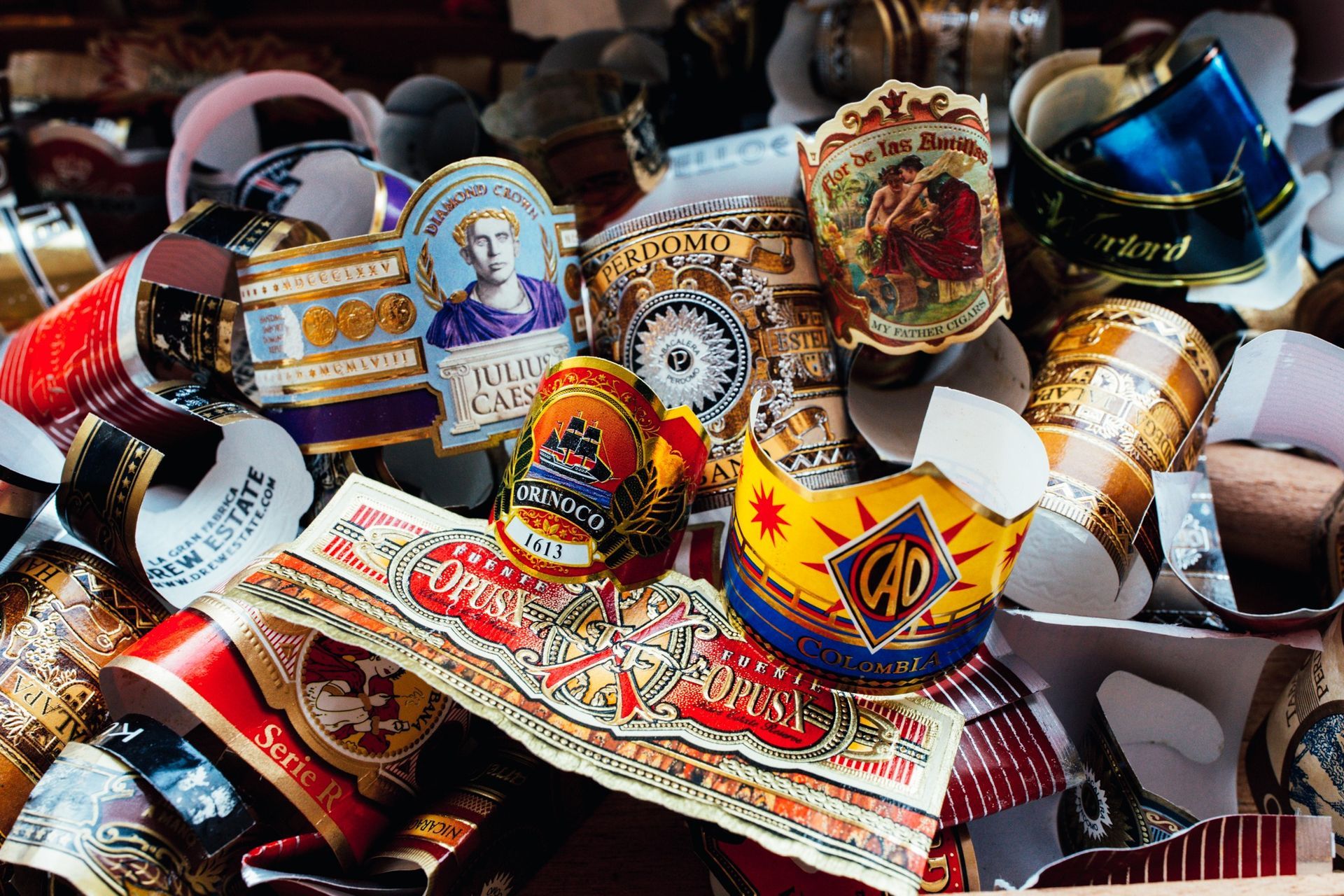 Assortment of colorful decorative ribbon or label badges piled together in a box