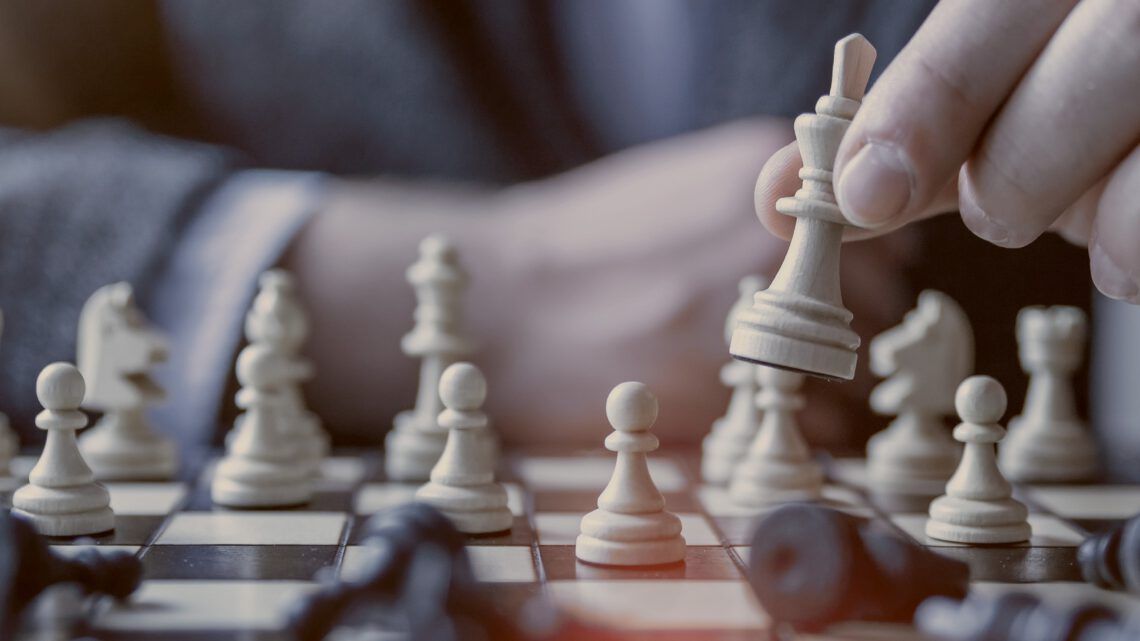 a person playing a game of chess to illustrate entrepreneurs evaluating franchises