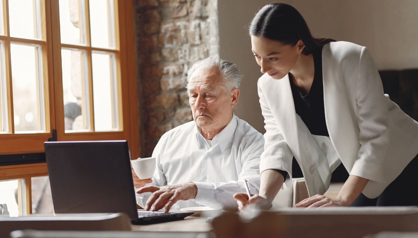 Senior veteran checking out affordable franchises for veterans with a consultant