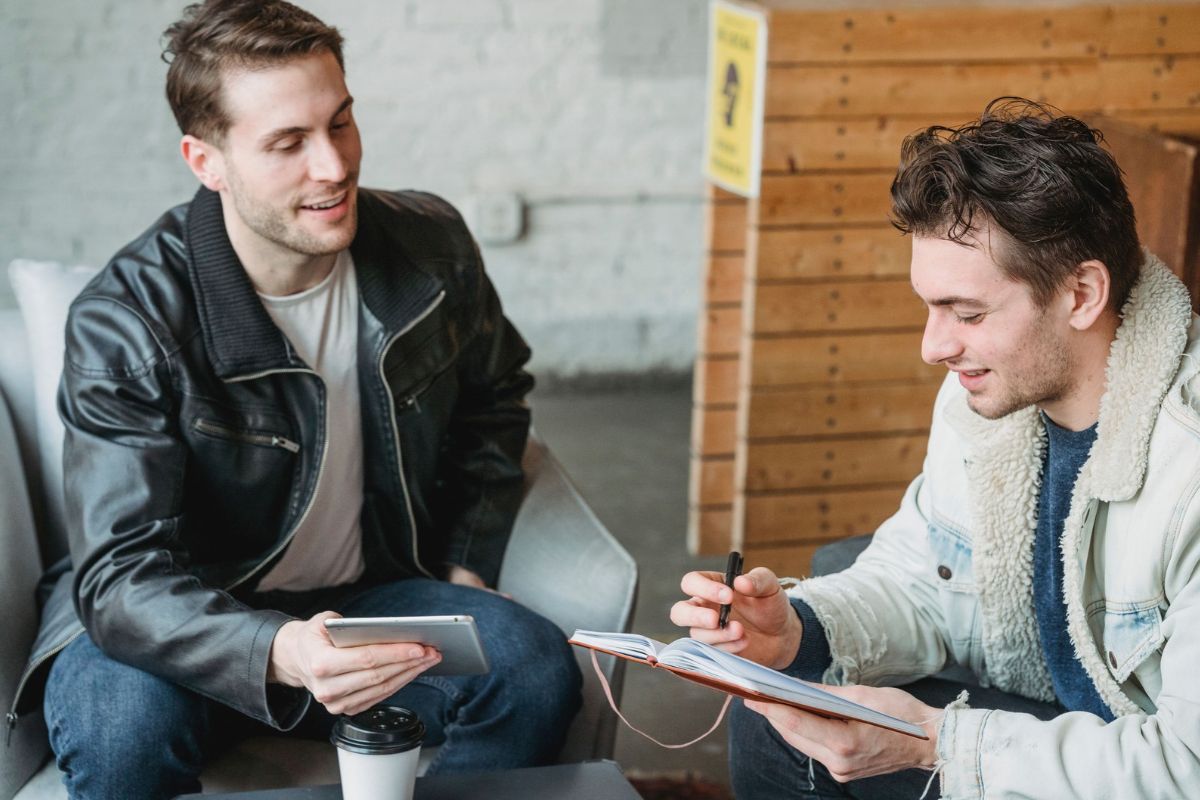 Two business owners in a meeting, exploring other benefits of investing in a small franchise