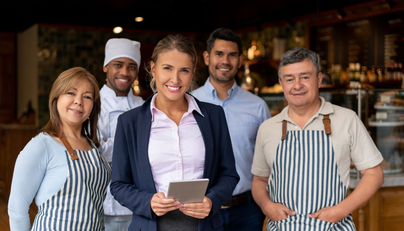 Happy team of business owner and staff highlighting the benefits of owning a franchise