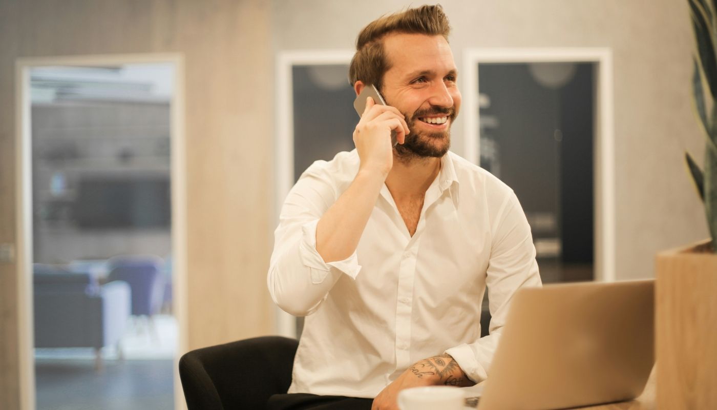 Businessman talking on the phone while choosing a franchise model