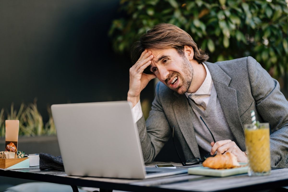 Angry businessman working on laptop, a representation of the 
