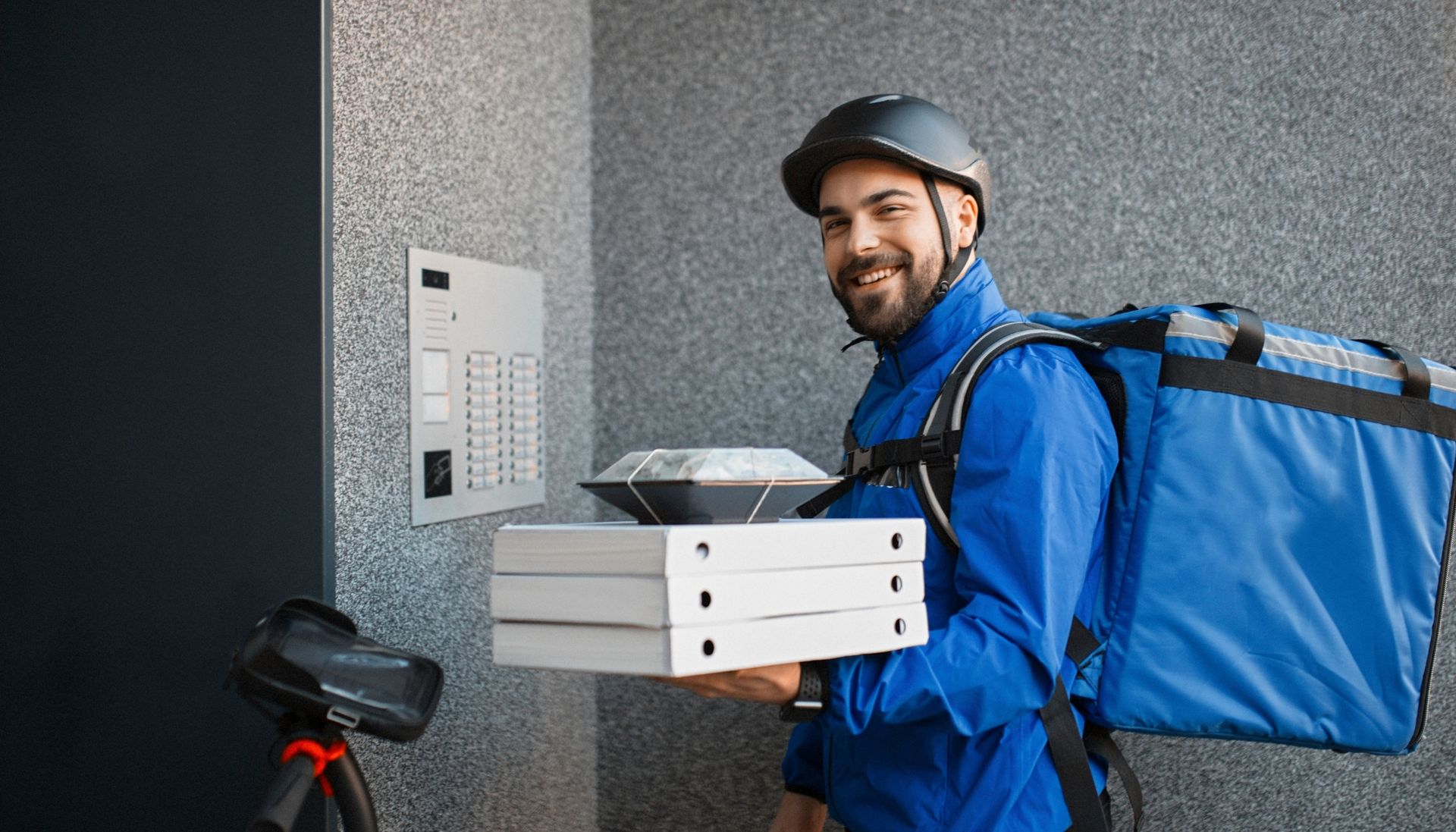 A young man working for food delivery services