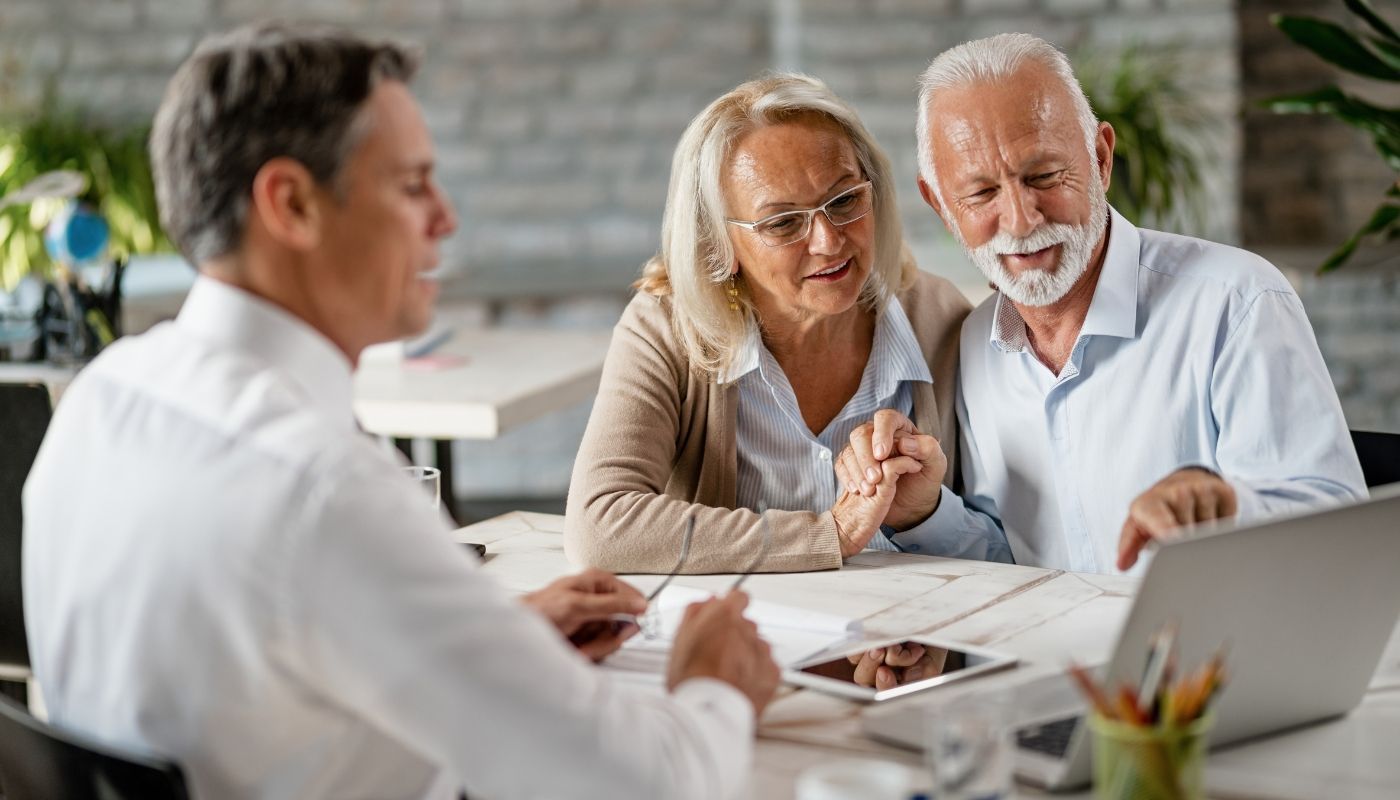 Happy senior couple speaking with a franchise consultant