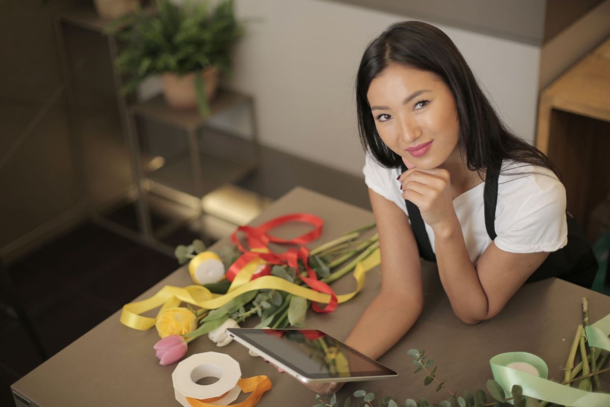 Young business owner holding a tablet, happy about her franchise investment