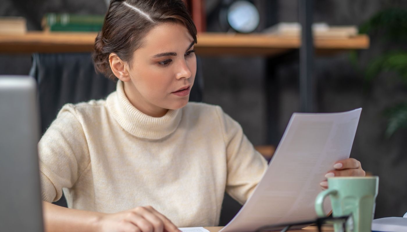 Young businesswoman examining a document related to franchise investment opportunities