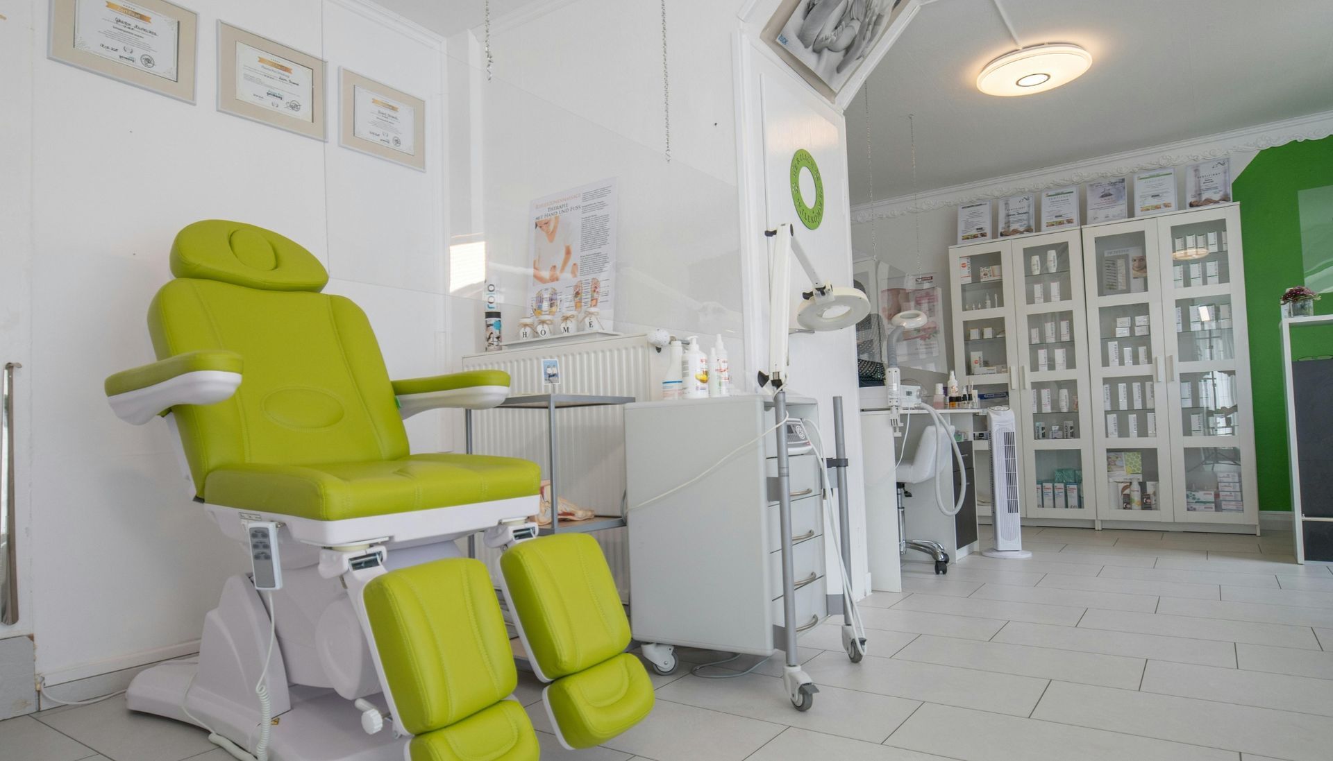 Clean and modern medical clinic interior with a green treatment chair and organized equipment, representing healthcare franchise opportunities in the growing healthcare sector