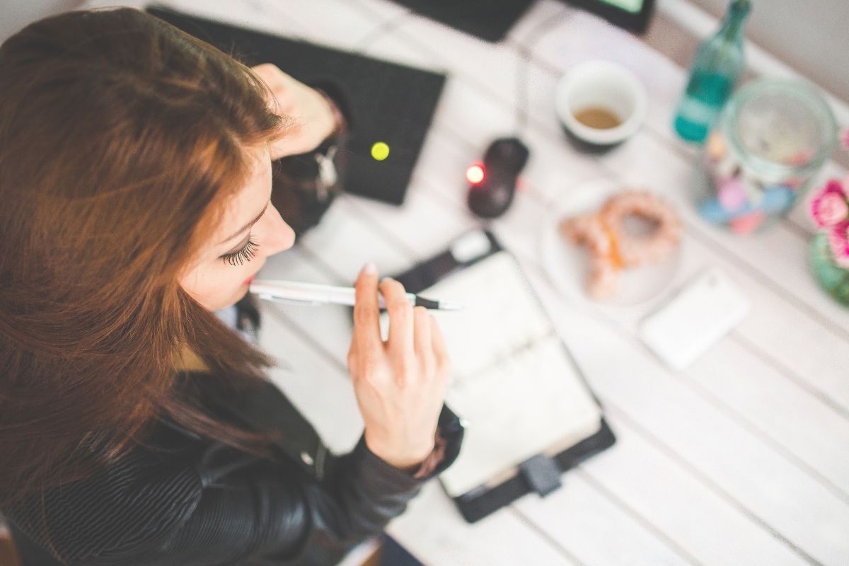 Female entrepreneur thinking about hiring staff members for her business