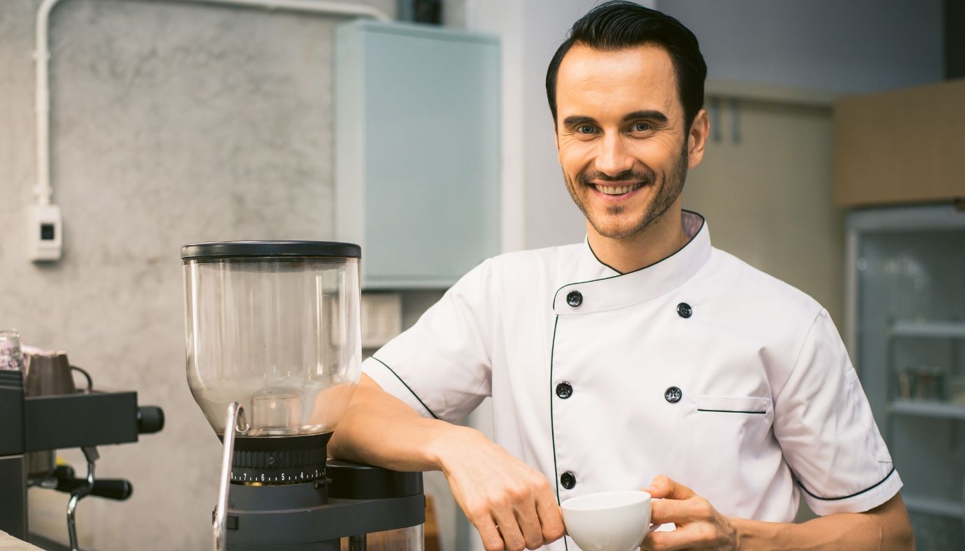 Cheerful barista in a coffee shop, learning how to get started in franchise development